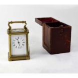A late 19th century French brass carriage clock with burgundy leather carrying case and key, the