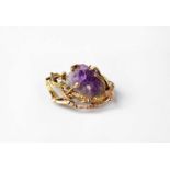 A 9ct gold brooch set with amethyst geode within an openwork bark textured mount, stamped 375,