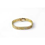 A 9ct gold flat link bracelet with white, rose and yellow gold links, stamped 375, approx. 17.2g.