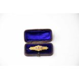 A Victorian 9ct gold mourning brooch set with blue stones and seed pearls, with glazed section