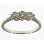 An 18ct white gold three-stone diamond ring, approx. 0.18ct, size Q, approx. 2.5g.