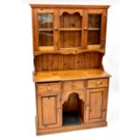 A reproduction pine dog kennel dresser, the upper section with boarded two-shelf plate rack with two