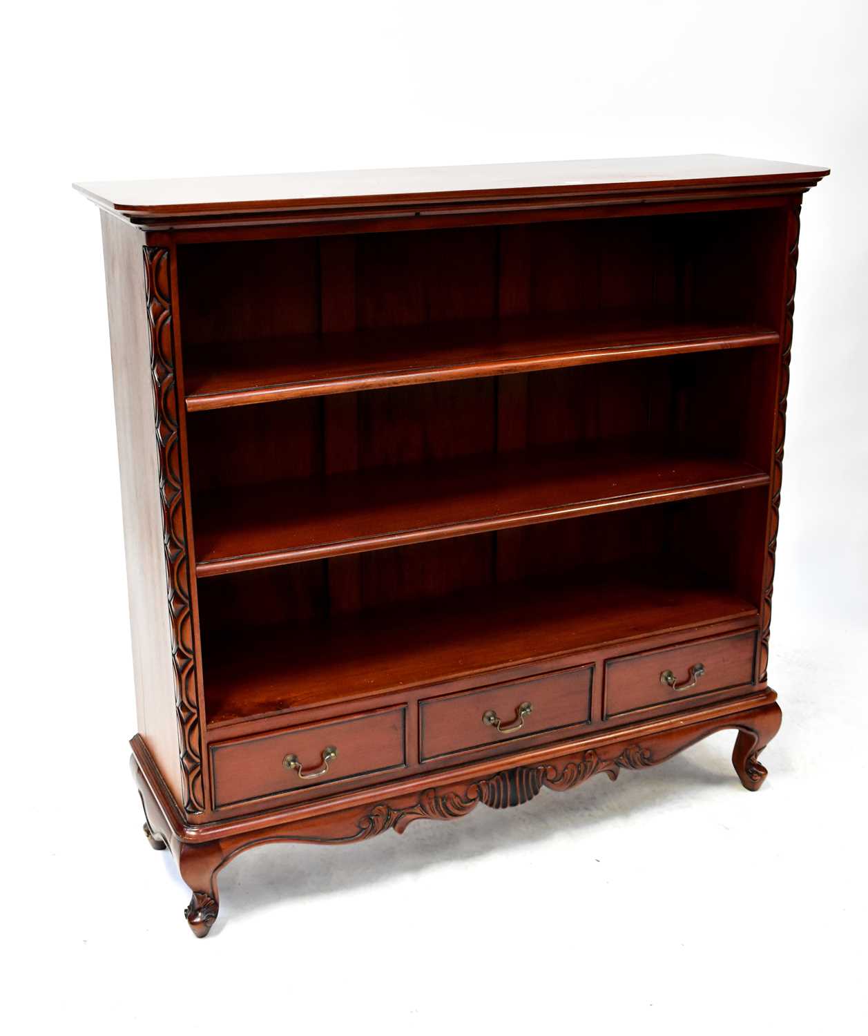 A reproduction mahogany open bookcase with two adjustable shelves above a base of three drawers