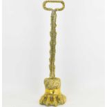 A 19th century brass doorstop modelled as a lion's paw, with acanthus leaf decorated handle,