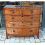 A Georgian crossbanded mahogany bow front chest of two short over three long drawers to outswept