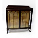 An early 20th century mahogany display cabinet with astragal glazed doors and glass side panels,