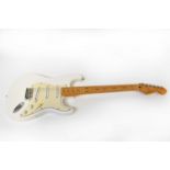 FENDER; a Stratocaster white body electric guitar, made in Mexico.