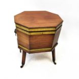 A George II brass bound mahogany wine cooler of octagonal form with lead-lined fitted interior, on a