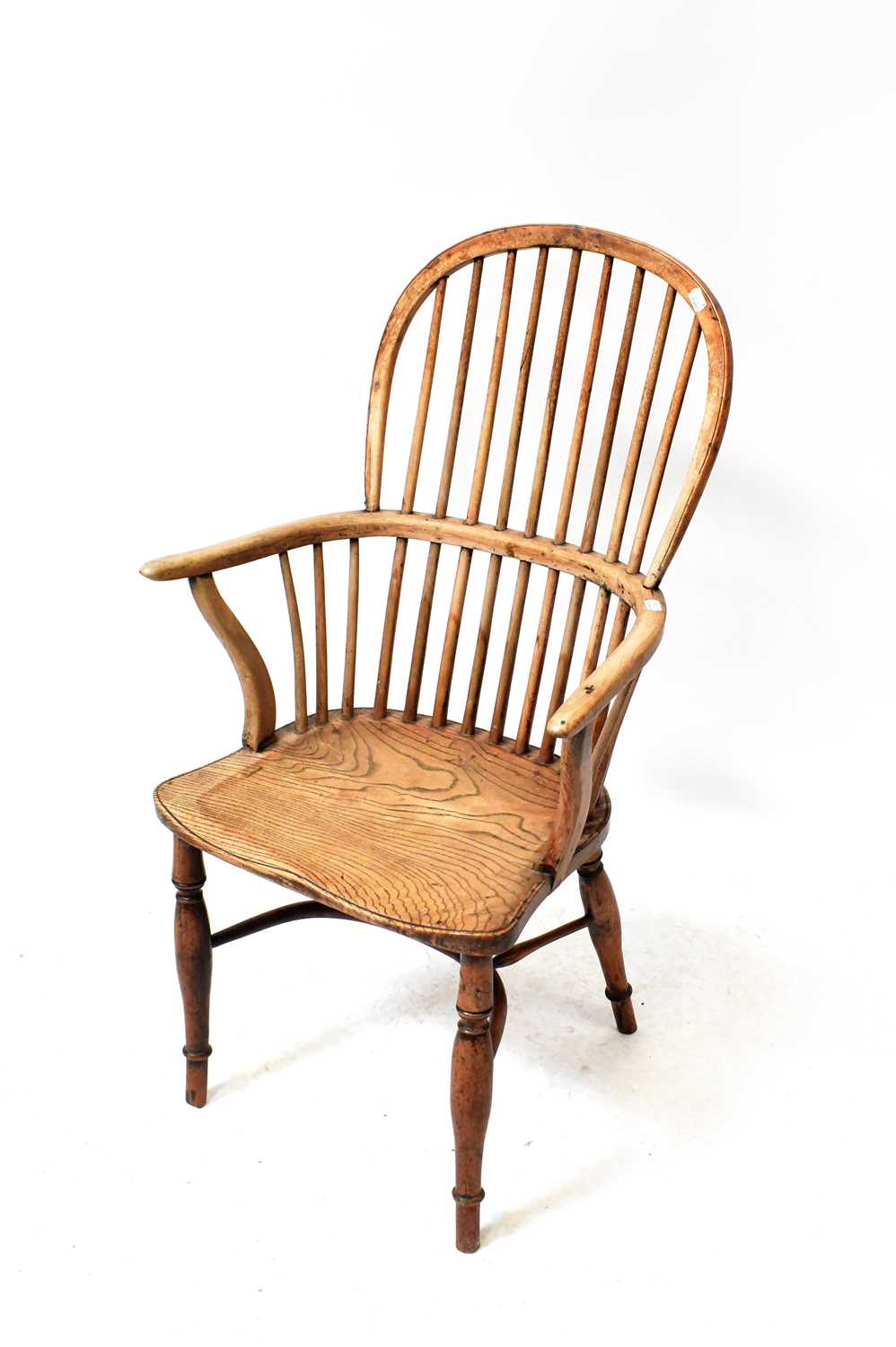 A Georgian yew wood Windsor chair with comb back and crinoline stretcher, height 103cm.Condition