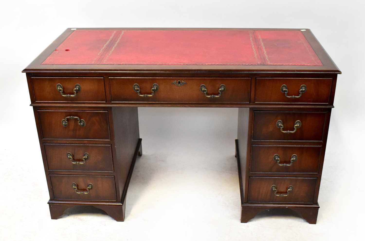 A Georgian-style mahogany pedestal desk with red leather insert top, on bracket feet, 75 x 122 x