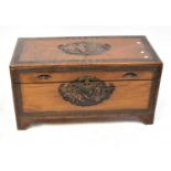 An early/mid-20th century Japanese camphor wood chest with carved panel decoration to shaped bracket