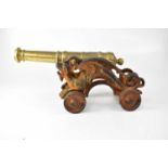 A late 19th century brass ships' warning cannon, on metal dragon wheeled stand, length 46cm.