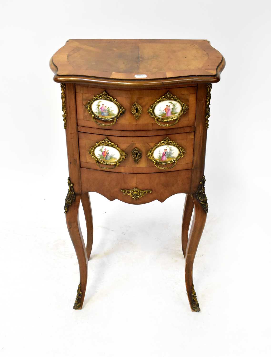 A reproduction burr walnut and satinwood bow-front bedside chest of two drawers with Limoges-style