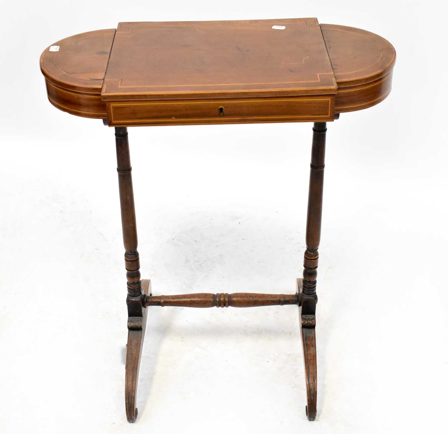 An Edwardian lozenge-shaped mahogany sewing table with three-section lift-up fitted top, 76 x 65 x