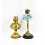 A Victorian paraffin lamp with painted blue glass font, raised on a brass column to a circular