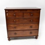A Victorian mahogany chest of two short over three long graduated drawers, on turned feet, with