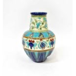 BURMANTOFTS; an early 20th century baluster vase with long neck, cream ground with turquoise, blue