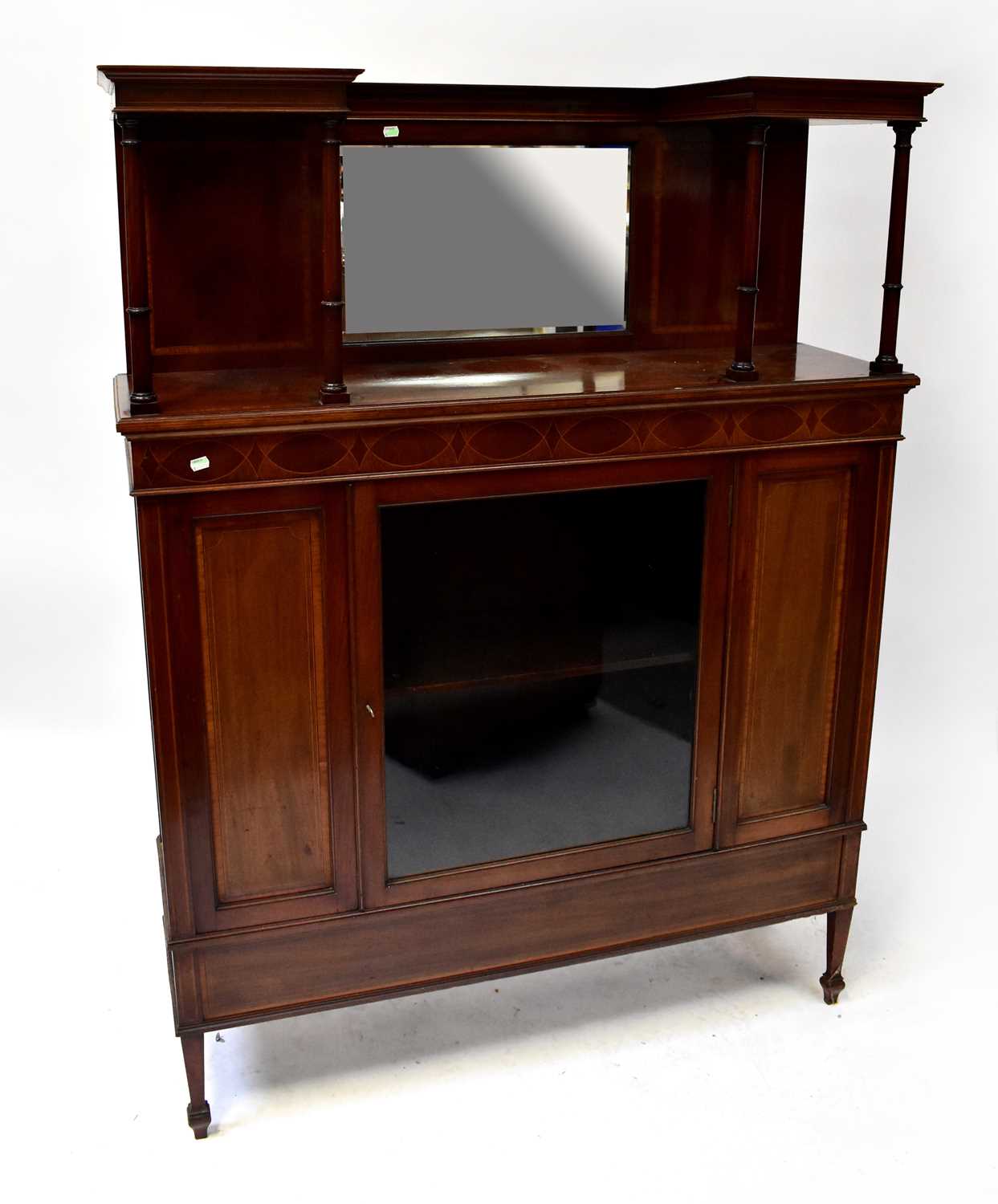 An Edwardian inlaid mirror back display cabinet with galleried top above single glazed door, on
