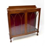 A mid-20th century mahogany display cabinet with twin astragal glazed doors, to paw supports, 118