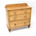 A pine chest of three graduated drawers, raised on tulip feet, 85 x 83 x 35cm.