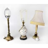 Three non-matching table lamps, comprising an onyx and brass example, a brass lamp on stepped square
