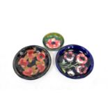 MOORCROFT; a poppy pattern dish with impressed marks and blue signature, diameter 18.5cm, a