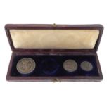 Three Victorian Maundy silver coins 1865, one, two and four pence denominations, in a leather