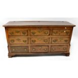 A Georgian oak mule chest with lift-up top and six faux drawers above three short drawers, on ogee