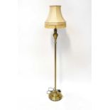 A contemporary brushed yellow metal standard lamp to circular spreading base, height 118cm.