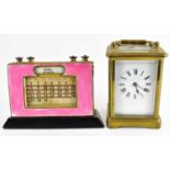 A French brass and glazed side carriage clock, the white enamelled dial set with Roman numerals,