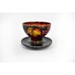 MOORCROFT; a grape and vine pattern footed bowl with blue, brown and red ground, impressed marks and