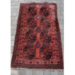 A late19th/early 20th century large Persian rug with two rows of four guls on a red ground, 205 x