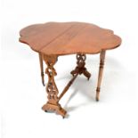 A Victorian walnut Sutherland table with shaped top and pierced side supports, on brass castors,