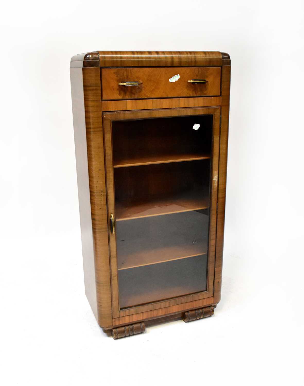 A 1930s walnut display cabinet with single drawer, on stylised bracket feet, 128 x 64 x 33cm.