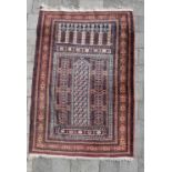 A late 19th/early 20th century Middle Easter prayer rug with temple motifs and repeating patterns,