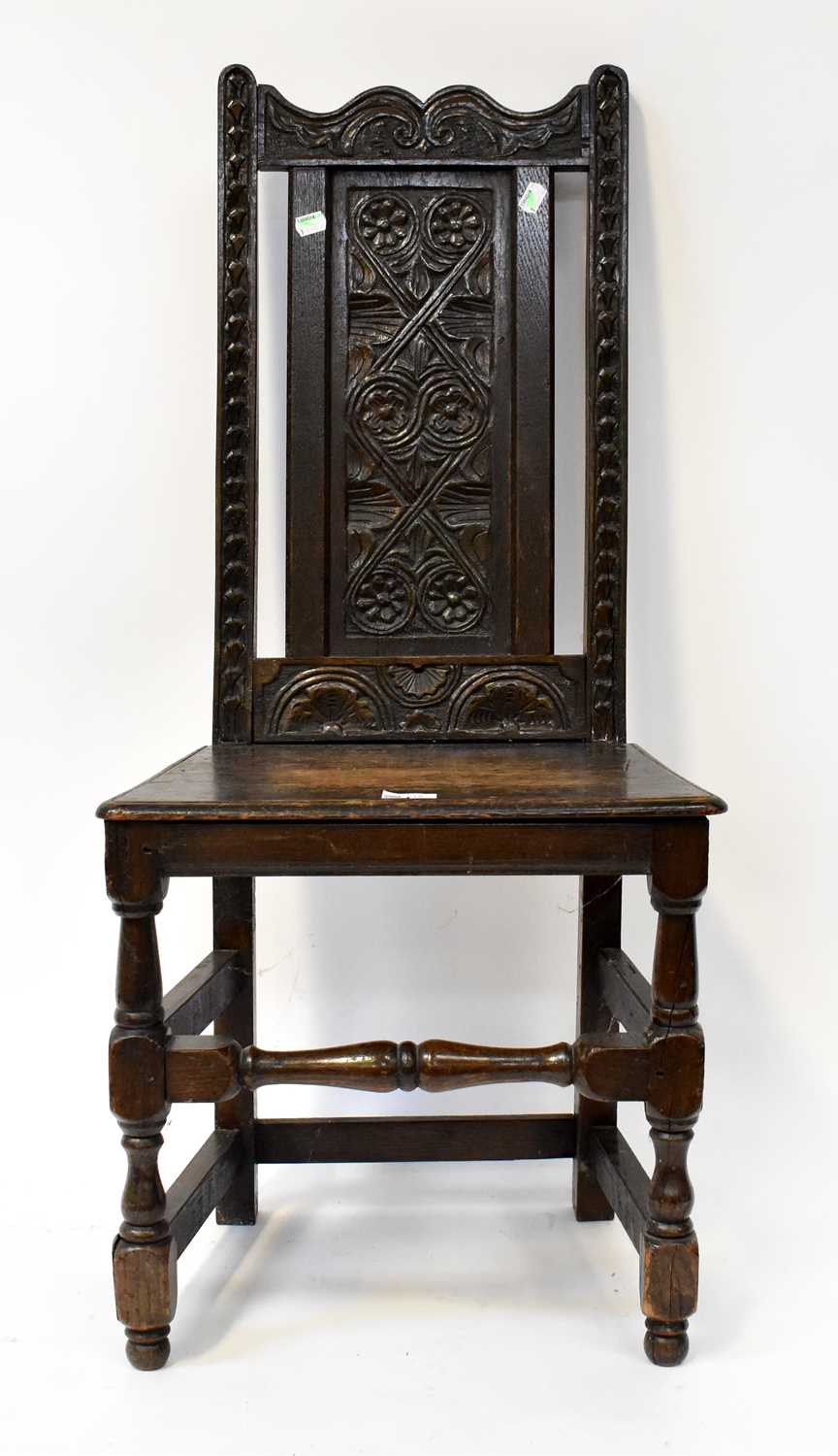 A Georgian oak joint chair with floral carved backrest, on block and turned legs, height 99cm.