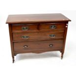 An Edwardian walnut chest of two short over two long drawers, raised on turned supports to