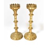 A pair of 19th century gilt brass ecclesiastical pricket candlesticks with leaf and grape borders,