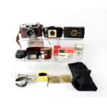 A small collection of cameras and accessories to include a Taron VR, a Kodak Brownie 127, a Kodak