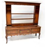 A late 18th/early 19th century oak dresser, the open back top with three shelves flanked by two