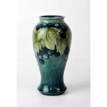 MOORCROFT; a blue ground baluster vase with grape and leaf design, impressed mark to base, height