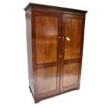 An early 20th century mahogany double wardrobe with panelled door and Greek Key moulded cornice,