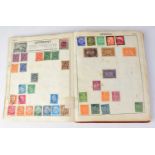 A sparsely filled 'The Victory All-British Stamp Album' with various stamps, mostly postmarked (