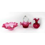 Three pieces of cranberry glass comprising shaped bowl, basket and jug (3).