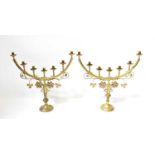 A pair of late 19th century ecclesiastical brass seven-light candlesticks with scroll and foliate