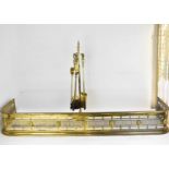 An early 20th century brass fender with pierced centre and applied rosettes, 116 x 30 x 20cm, and
