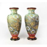ROYAL DOULTON; a pair of Chine ware vases decorated with flowers on a green/grey base, burgundy
