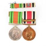 A WWII defence medal and a Faithful Service Special Constabulary medal, both with ribbons, awarded