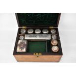 A 19th century rosewood travelling toiletries box, lift-up lid with blank shield cabochon,