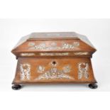 A Victorian rosewood sewing box of sarcophagus form inlaid with mother of pearl leaves and ferns,